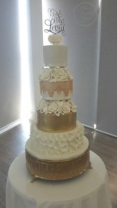 Gold & White Large Wedding Cake White Roses, Ruffles on Wedding Cake Edible Lace, Roses inbetween Pillars on Wedding Cake Gold Ornate Cake Stand